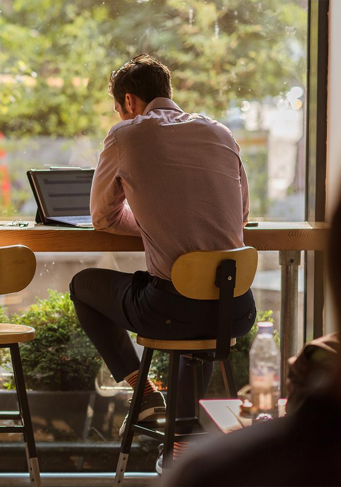 A man working on a laptop in a cafe in Victoria, BC