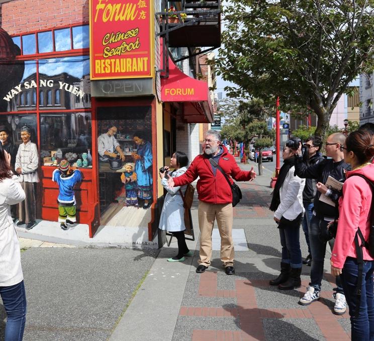 A guide showcases Victoria's Chinatown on a Discover the Past walking tour in Victoria, BC