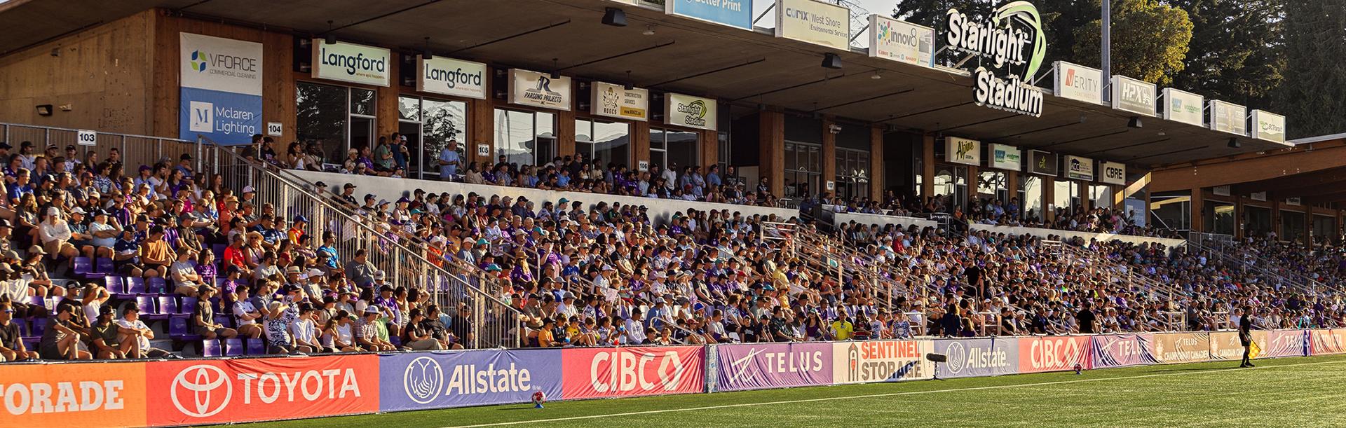 A crowd at Starlight Stadium dressed in purple cheer on Pacific FC soccer team in Greater Victoria, BC