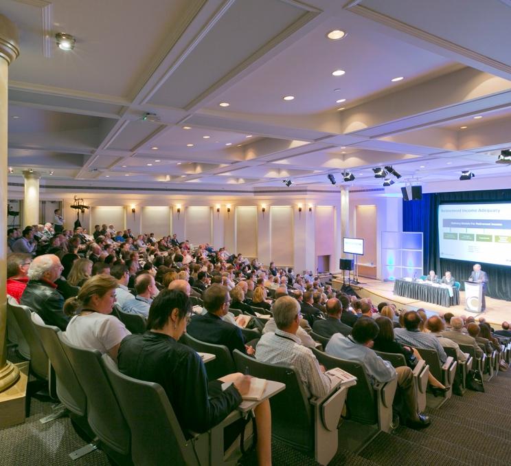 Delegates seated in the theatre during a presentation at a conference the Victoria Conference Centre
