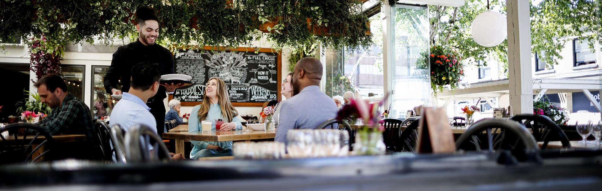 A group of delegates dines at 10 Acres Bistro in Victoria, BC