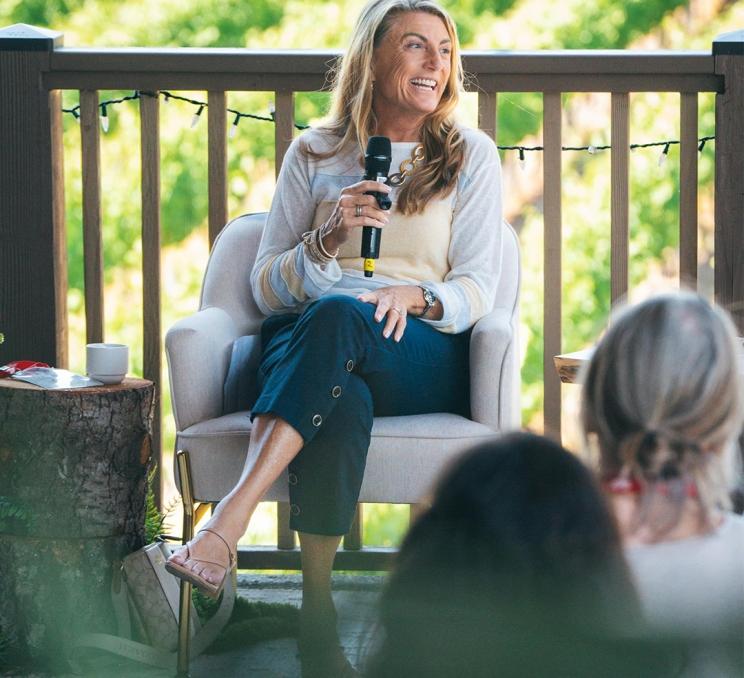 A woman speaks at a vineyard during a conference in Victoria, BC