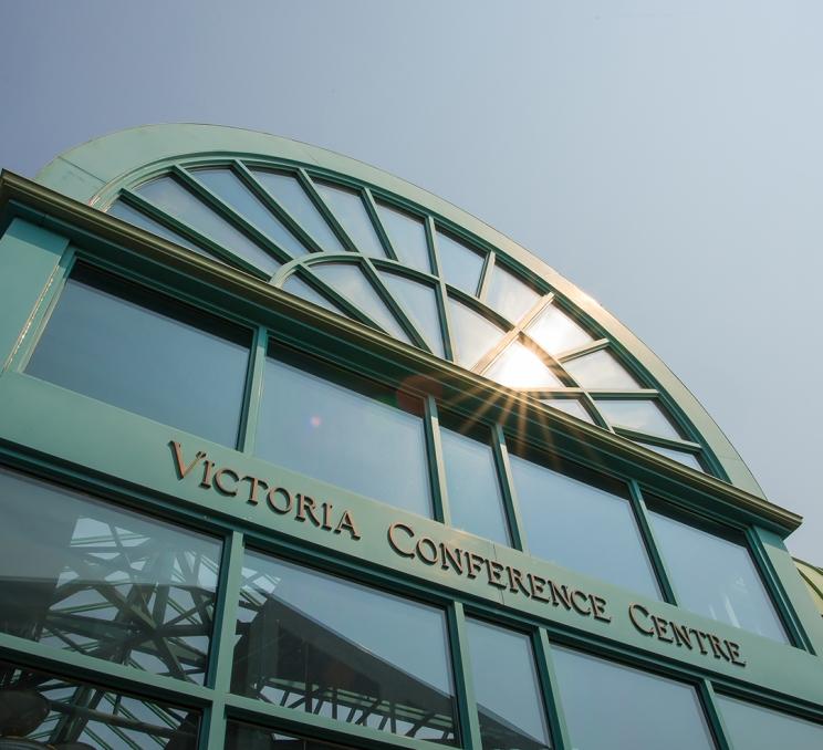 Sun glistens off the glass overhead of the entranceway at the Victoria Conference Centre in Victoria, BC