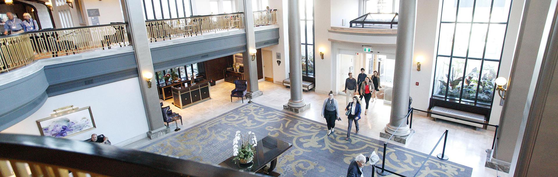 A group of delegates enter the Fairmont Entrance lobby in Victoria, BC