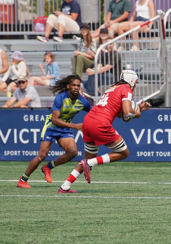 A Rugby Canada player runs a ball in for a try at a rugby match in Victoria, BC