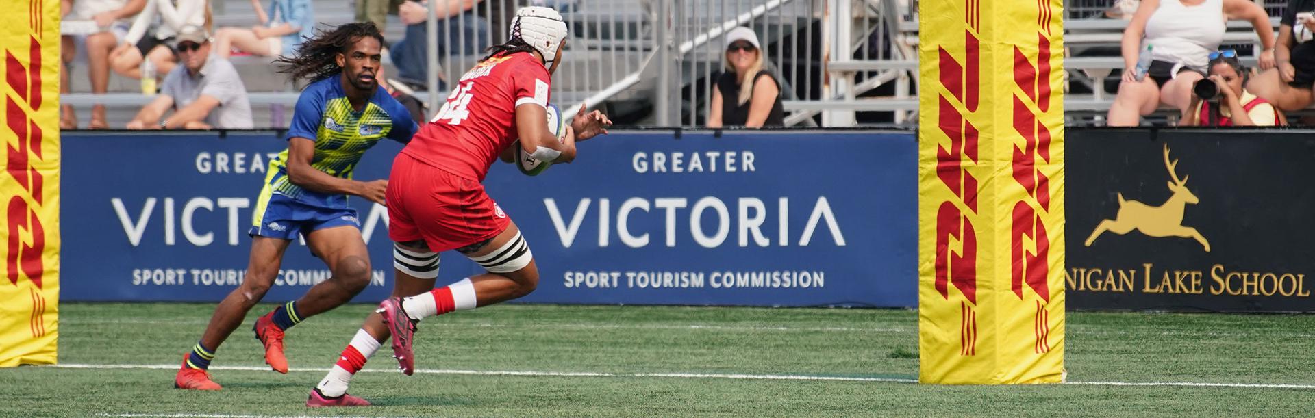 A Rugby Canada player runs the ball in for a try at a rugby match in Victoria, BC