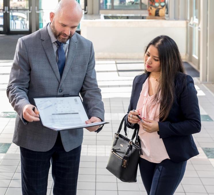 A Destination Greater Victoria employee and a client review some documents at the Victoria Conference Centre in Victoria, BC