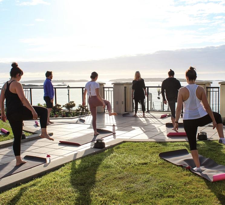 A group participates in an outdoor Yoga class in Victoria, BC