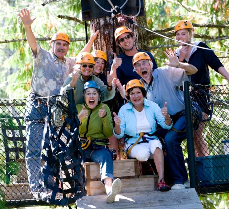 A group of delegates poses for a photo during a zipline tour in Victoria, BC
