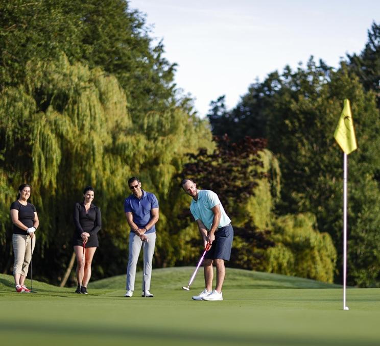 A group of delegates on the green at a golf course in Victoria, BC
