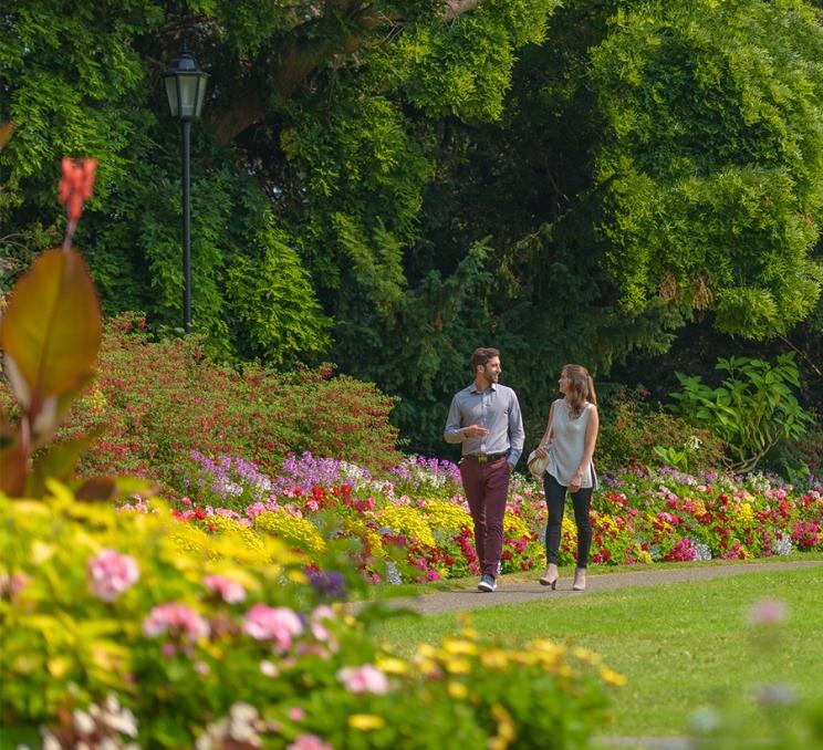A pair of delegates walk through Beacon Hill Park in Victoria, BC
