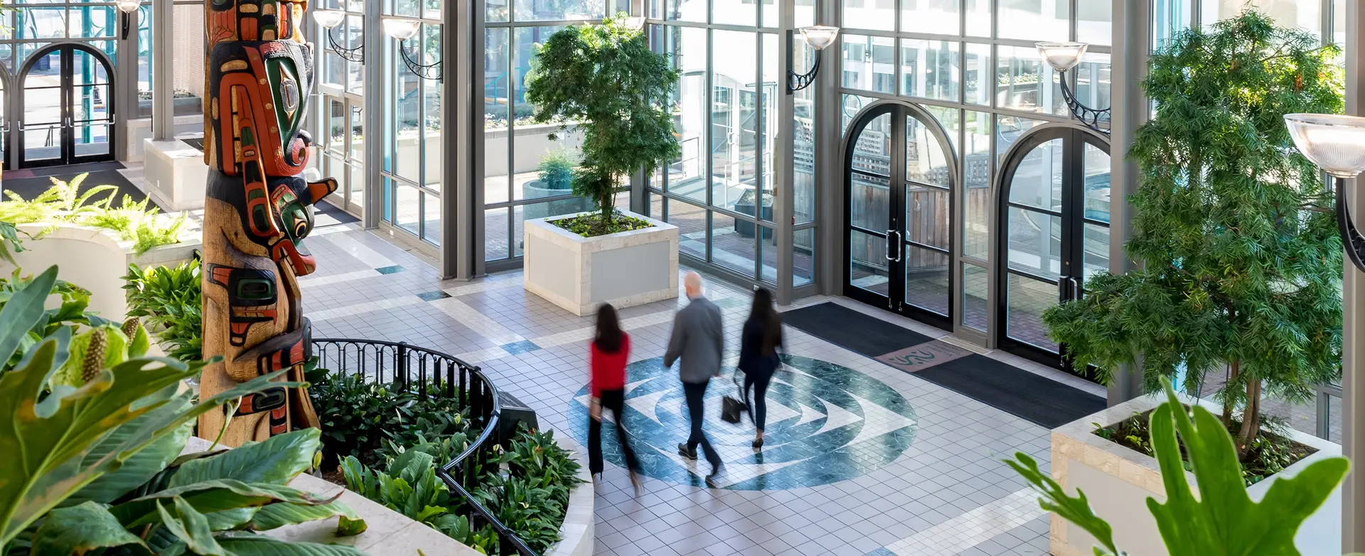 The bright and airy atrium of the Victoria Convention Centre, showcasing sleek design and large windows.