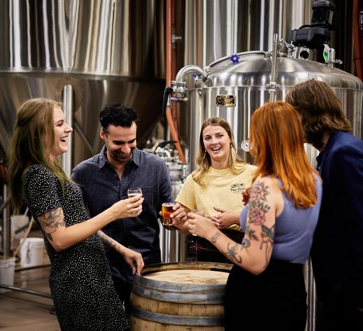 A guide leads a brewery tour and tasting at Macaloney's Island Distillery in Victoria, BC