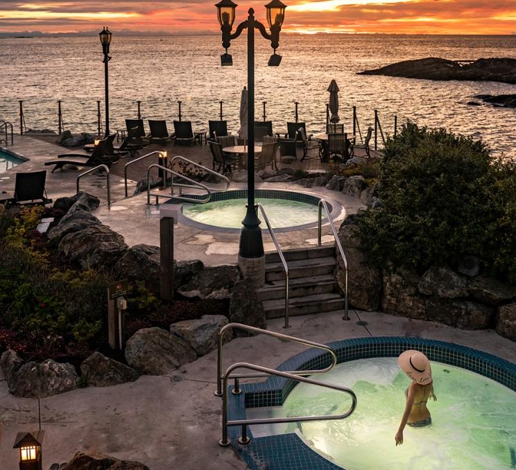 A woman soaks in the seaside mineral pools at the Oak Bay Beach Hotel in Victoria, BC