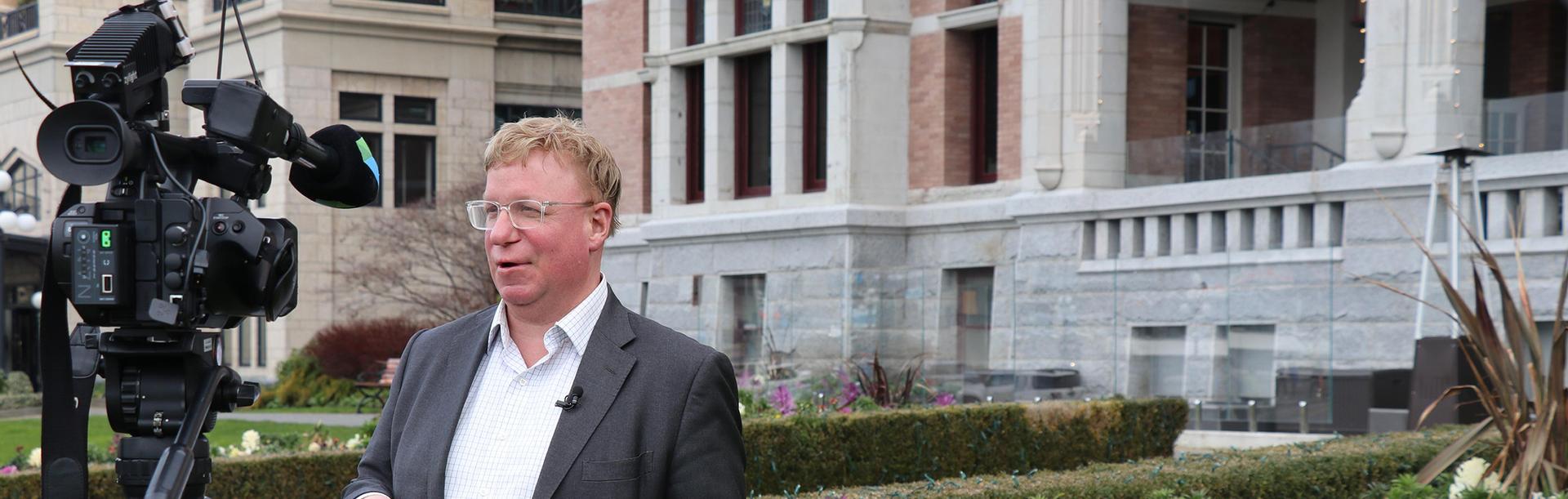 Destination Greater Victoria's CEO is interviewed for Victoria Flower Count outside the Fairmont Empress Hotel in Victoria, BC
