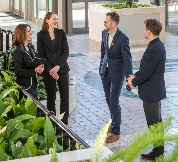 A group of professionals chatting about their upcoming conference at the Victoria Conference Centre in Victoria, BC