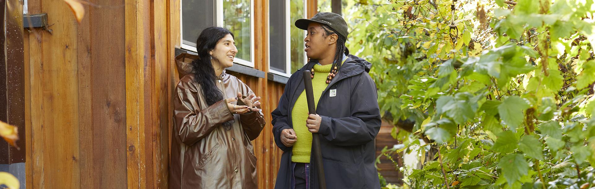 Two people have a conversation about composting in their facility in Victoria, BC